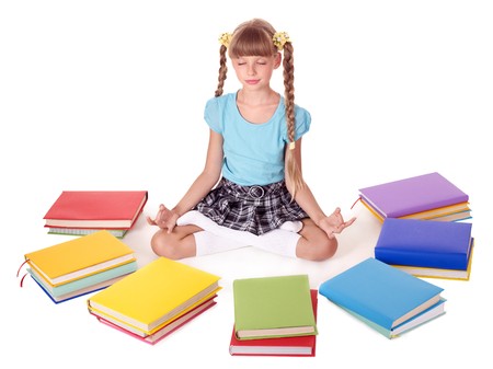 School child sitting lotus position. Isolated.の写真素材