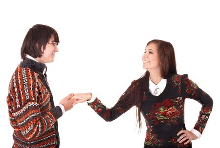 Happy teenage couple talking on white background.の写真素材