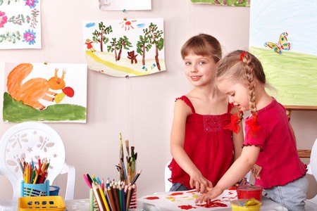 Children painting colour paints in preschool.の写真素材