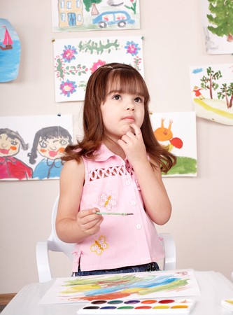 Little girl painting picture in art class.の写真素材