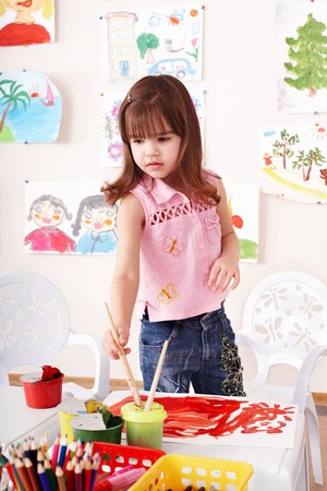Little girl paint picture in preschool.の写真素材