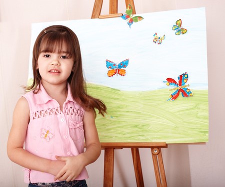 Little girl with easel in preschool.の写真素材