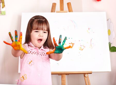 Little girl making handprints with paint.の写真素材