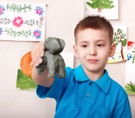 Little boy playing with clay.の写真素材