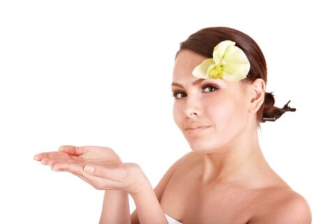 Beautiful girl with orhid flower in spa . Isolated.の写真素材