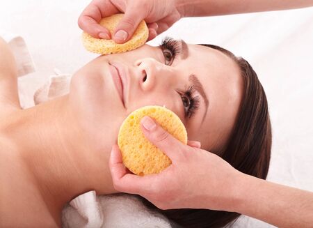 Beautiful young girl in spa. Facial massage.の写真素材