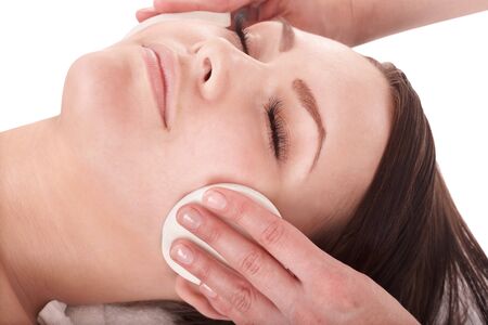 Beautiful young girl in spa. Facial massage.の写真素材