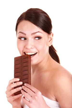 Beautiful girl bite chocolate bar. Isolated.の写真素材