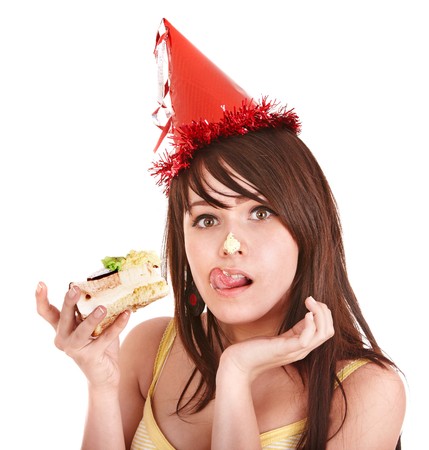 Happy young woman eating cake. Isolated.の写真素材