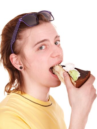 Young man eating chocolate cake. Isolated.の写真素材