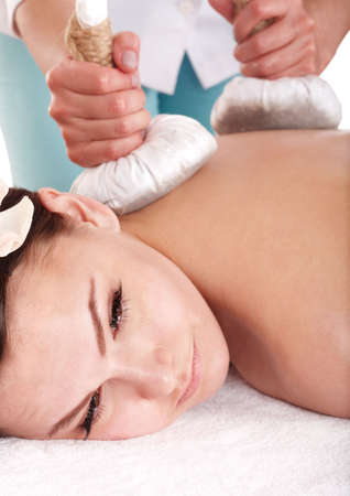 Girl  having Thai herb compress massage in beauty spa. Body care.の素材 [FY3108122506]