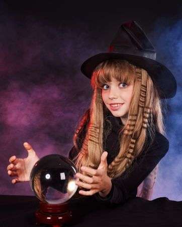Little girl witch holding crystal ball.の写真素材