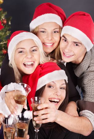 Group young people in santa hat drinking champagne at nightclub.の写真素材