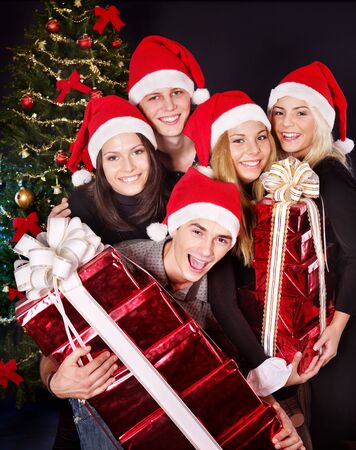 Group young people in santa hat drinking champagne at nightclub.の写真素材