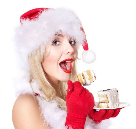 Christmas girl in red santa hat and cake on plate. Isolated.の写真素材