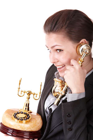 Happy businesswoman with golden phone. Isolated.の写真素材