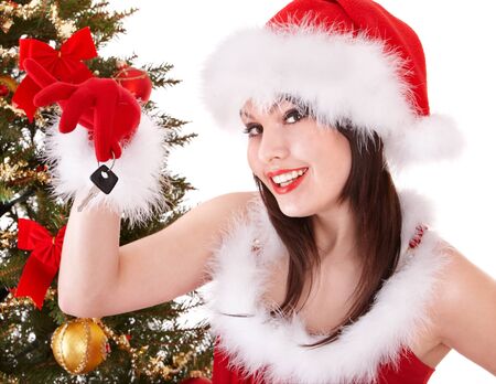 Christmas girl in santa hat holding auto keys. Isolated.の写真素材