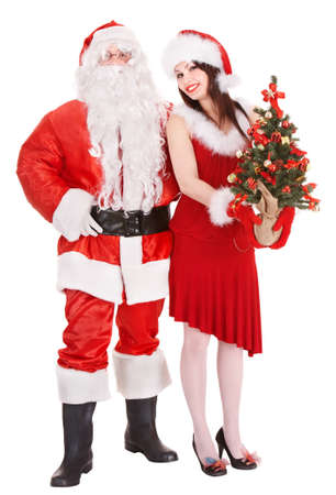 Santa claus and girl holding christmas tree. Isolated.の写真素材