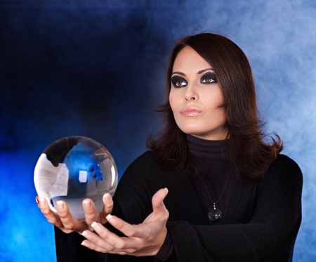 Young woman with crystal ball. Fortune telling.の写真素材