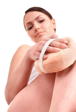 Young woman scrubbing body. Isolated.の写真素材