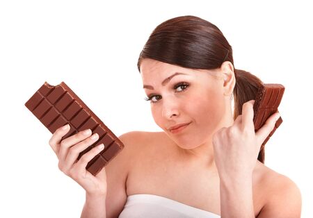 Beautiful girl bite chocolate bar. Isolated.の写真素材