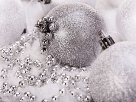Christmas ball and silver beads in snow.の写真素材