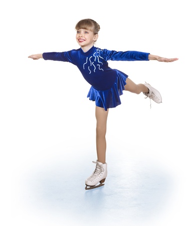 Happy young girl figure skating. Isolated.の写真素材