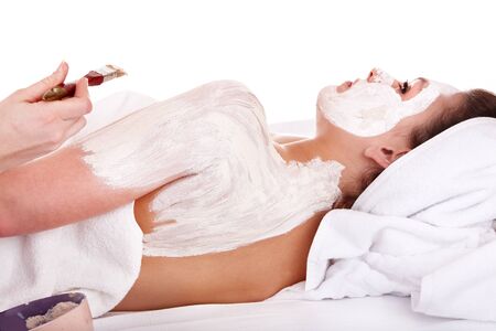 Beautician apply clay body mask  to girl. Skin care.の写真素材