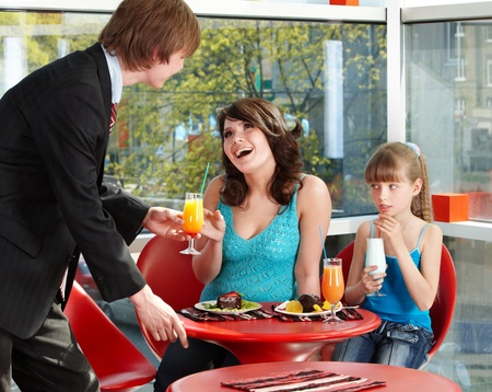 Happy family with child in cafe. Parenting.の写真素材
