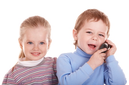 Little girl and boy talking by phone.の写真素材