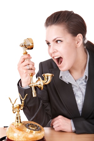 Aggressive businesswoman  talking by  golden  phone. Isolated.の写真素材
