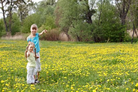 Children in field with flower. Outdoor.の写真素材