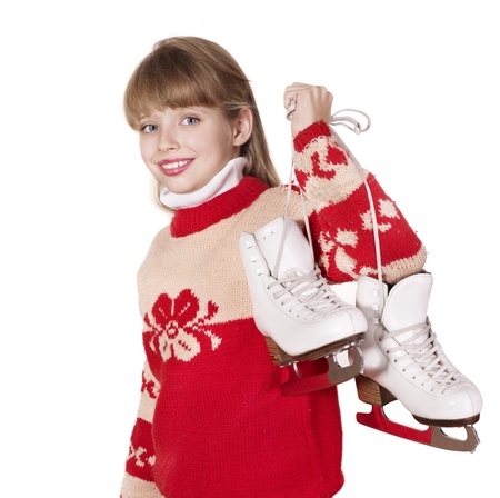Child in santa hat holding figure skates.の写真素材