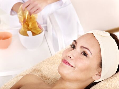 Young womanl with gold facial mask.の写真素材
