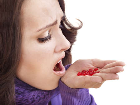 Young woman having flu takes pills.の写真素材