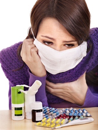 Young woman having flu takes pills.の写真素材