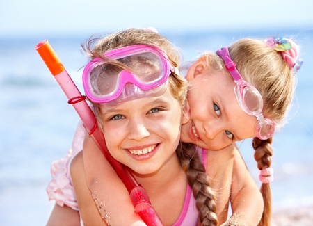 Children playing on  beach. Snorkeling.