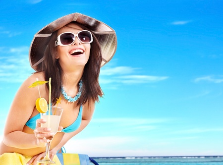 Girl in bikini drink juice through a straw.の写真素材