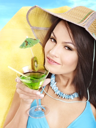 Girl in bikini drink juice through a straw.の写真素材