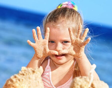 Little girl  playing on  beach.の写真素材