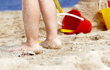 Child leg in sand  on  beach.の写真素材
