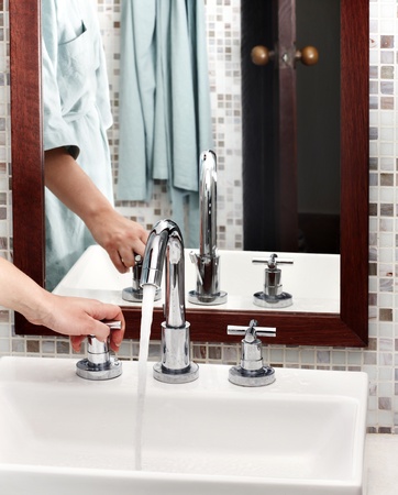 Water runs from  tap in bathroom.の写真素材