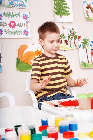 Little girl paint picture in preschool.の写真素材