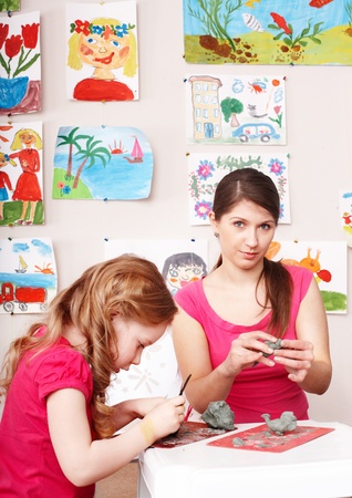 Little girl and mother playing with  clay. の写真素材