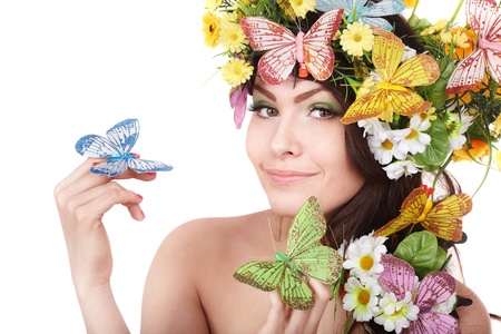 Girl with butterfly and flower on head. Spring hair. Isolated.の写真素材