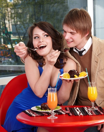 Loving couple eating cake in restaurant.の写真素材