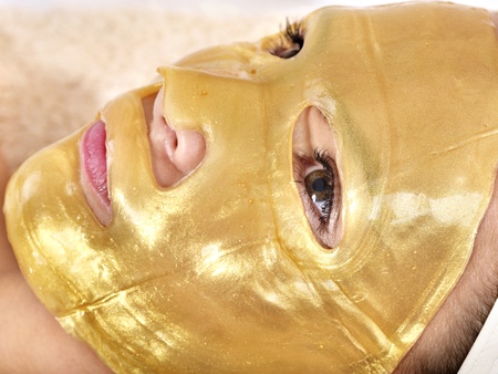 Young womanl with gold facial mask.の写真素材