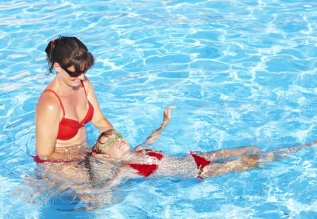 Swimming Instructor learn little girl swim.の写真素材
