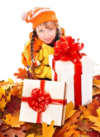 Little girl in autumn orange leaves holding  gift box. Outdoor.の写真素材