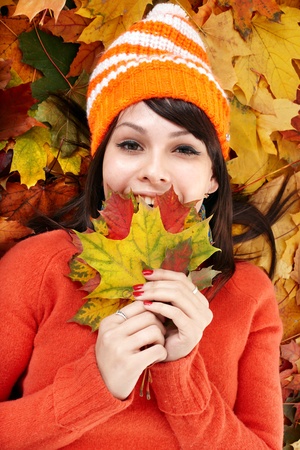Young woman in autumn orange leaves. Outdoor.の写真素材